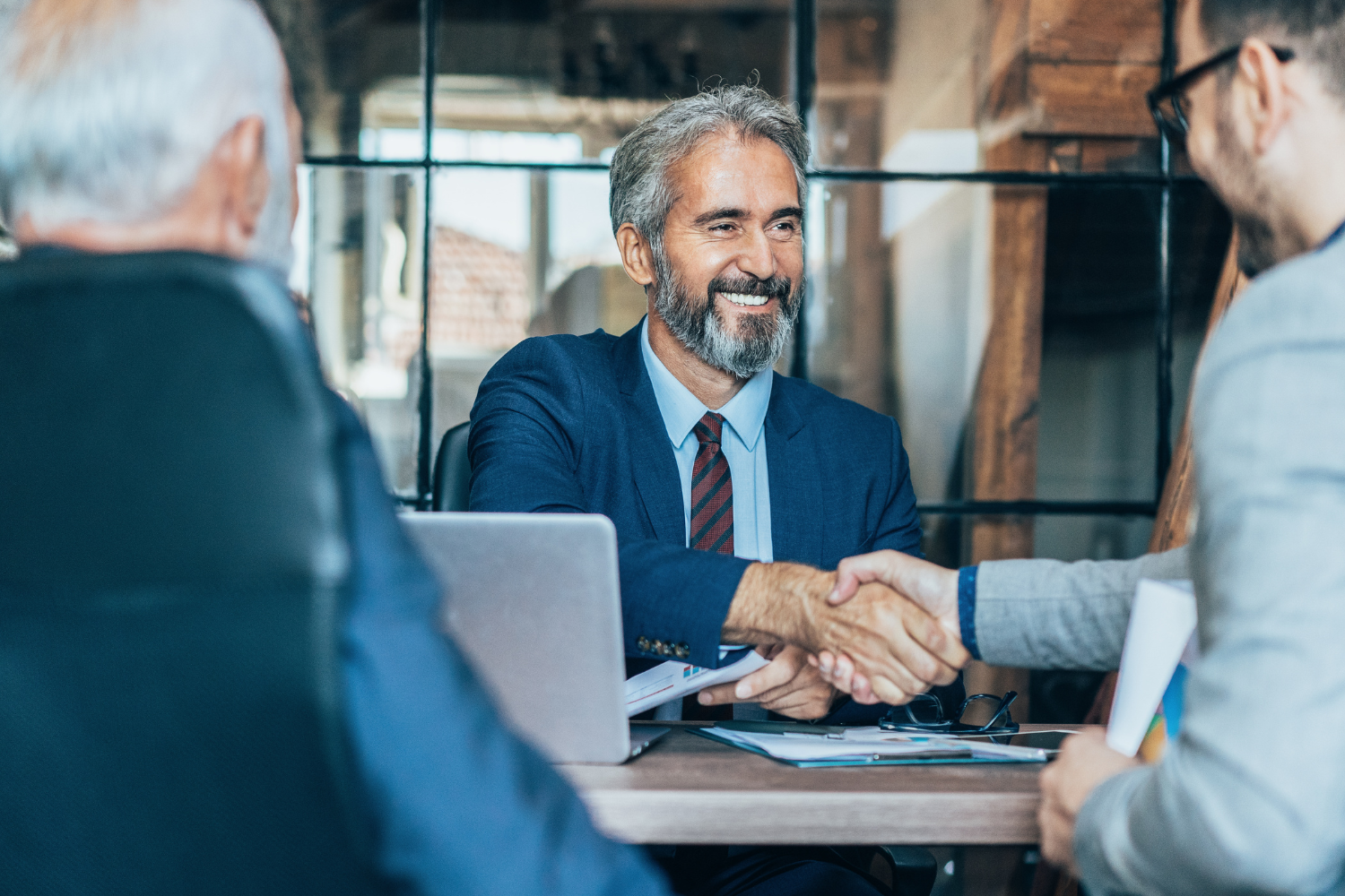 Business meeting and handshake representing tax-free registered office services, local business tax optimization and company administration in Hungary